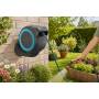 Wall-mounted hose reel RollUp S with garden hose watering flower beds